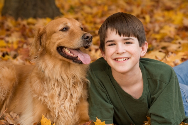 Teenager with Golden Retriever in the Fall